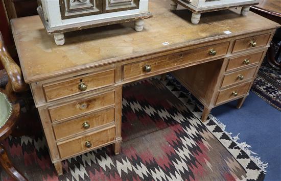 An early 20th century pine pedestal kneehole desk W.152cm